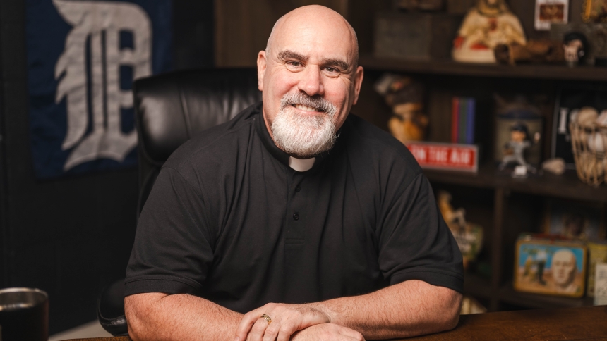 Photo of Fr. Joe Krupp sitting at desk